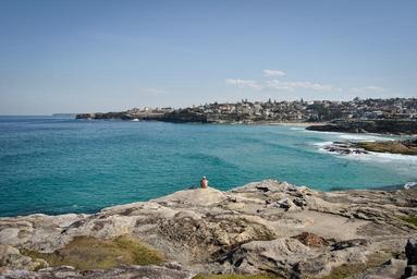 Man_Sitting_on_Seacoast_Rock.jpg