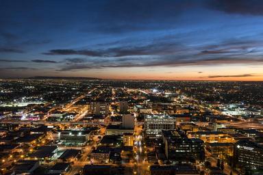 Nighttime skyline view of Los Angeles, California, looking west toward the setting sun LCCN2013631258.tif.tiff