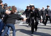 Flickr_-_Official_U.S._Navy_Imagery_-_Sailor_gives_a_high-five_to_a_child_while_marching_in_110th_annual_Boston_St._Patricks_Day_parade..jpg