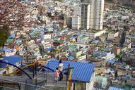 Man_and_Child_on_Staircase_Overlooking_Urban_City.jpg