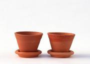 Terracotta-or-clay-gardening-pots-on-a-wooden-plank-on-a-white.jpg