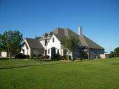 brick-home-blue-sky-green-lawn-290315.jpg