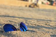 sunglasses-sand-beach-blue-light-961385.jpg