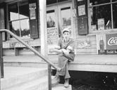 Boy_on_porch_of_general_store,_Roseland,_Virginia.jpg