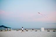 Male_Flying_a_Kite_on_an_Ocean_Beach.jpg