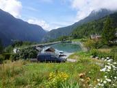 alpine-landscape-with-pond-house-and-green-grass.jpg