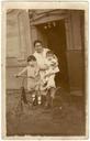 Two_kids,_their_mother,_and_a_trike._Real_photo_postcard_ca_1920,_probably_Spain..jpg