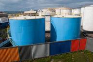 Industrial_silos_behind_multicolored_fence_in_Silo_Park,_Auckland.jpg