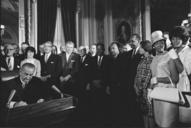 Photograph_of_President_Lyndon_Johnson_Signs_the_Voting_Rights_Act_as_Martin_Luther_King,_Jr.,_with_Other_Civil_Rights_Leaders_in_the_Capitol_Rotunda,_Washington,_DC,_08/06/1965.jpg