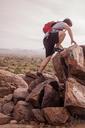 Boy_with_a_Red_Backpack_Rock_Climbing.jpg