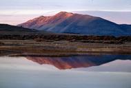 Sunrise at lake mountains in background reflected on lake.jpg