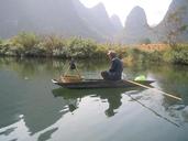 man-raft-china-yangshuo-river-271090.jpg