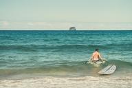 Male_Surfer_with_Surfboard_in_Ocean.jpg