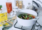 Stock-pot-on-a-stove-with-vegetables-cut-for-making-soup.jpg