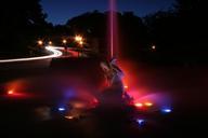 Como Park fountain in blue and red with traffic.jpg