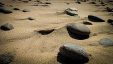 rocks-beach-wind-sand-ocean-555736.jpg