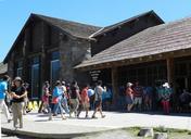 Old_Faithful_Lodge,_visitor_walking_in_front_of_building.jpg