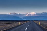 Empty-road-leading-to-snow-covered-mountains-Iceland.jpg