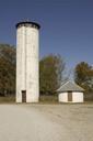 Tall white silo shaped wildlife observation tower with viewing spaces at top.jpg