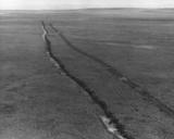 This aerial view shows the detrimental effect of driving vehicles over the tundra during thaw season.jpg