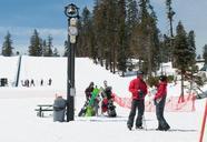 Sierra_at_Tahoe_staff_talking_by_pole_with_clock_and_bell.jpg