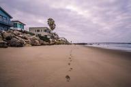 beach-houses-sand-footprints-rocks-924685.jpg