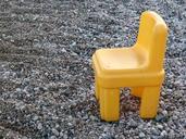 pebbles-stones-beach-yellow-chair-723921.jpg