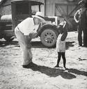 The_owner_of_the_Aldridge_Plantation_with_one_of_the_plantation_children_Leland_(vicinity)_June_1937.jpg