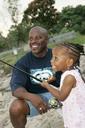 Dad and daughter fishing young girl learns to fish.jpg